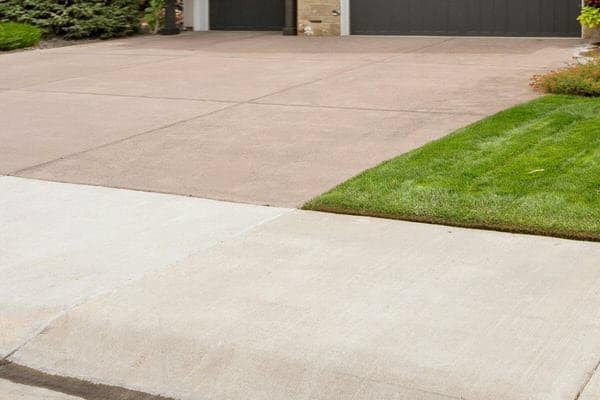 Coloured Concrete Driveway In Dark Beige And Cream Cross Over